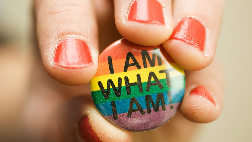 Bilde av en pin med regnbuefarger og teksten I am who I am