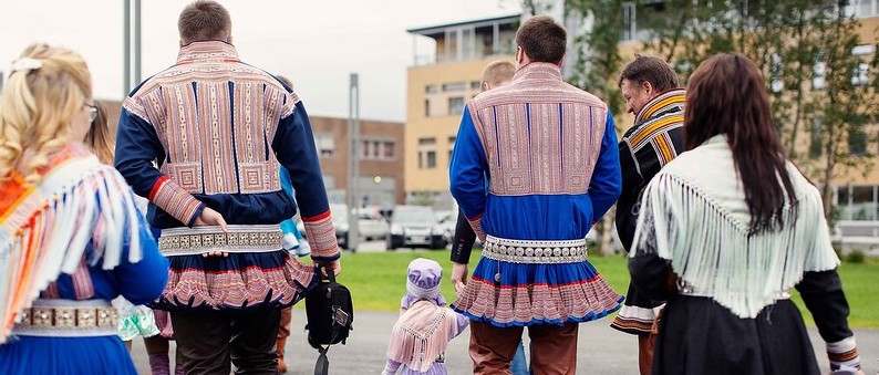 en gruppe menn og kvinner i samiske klær